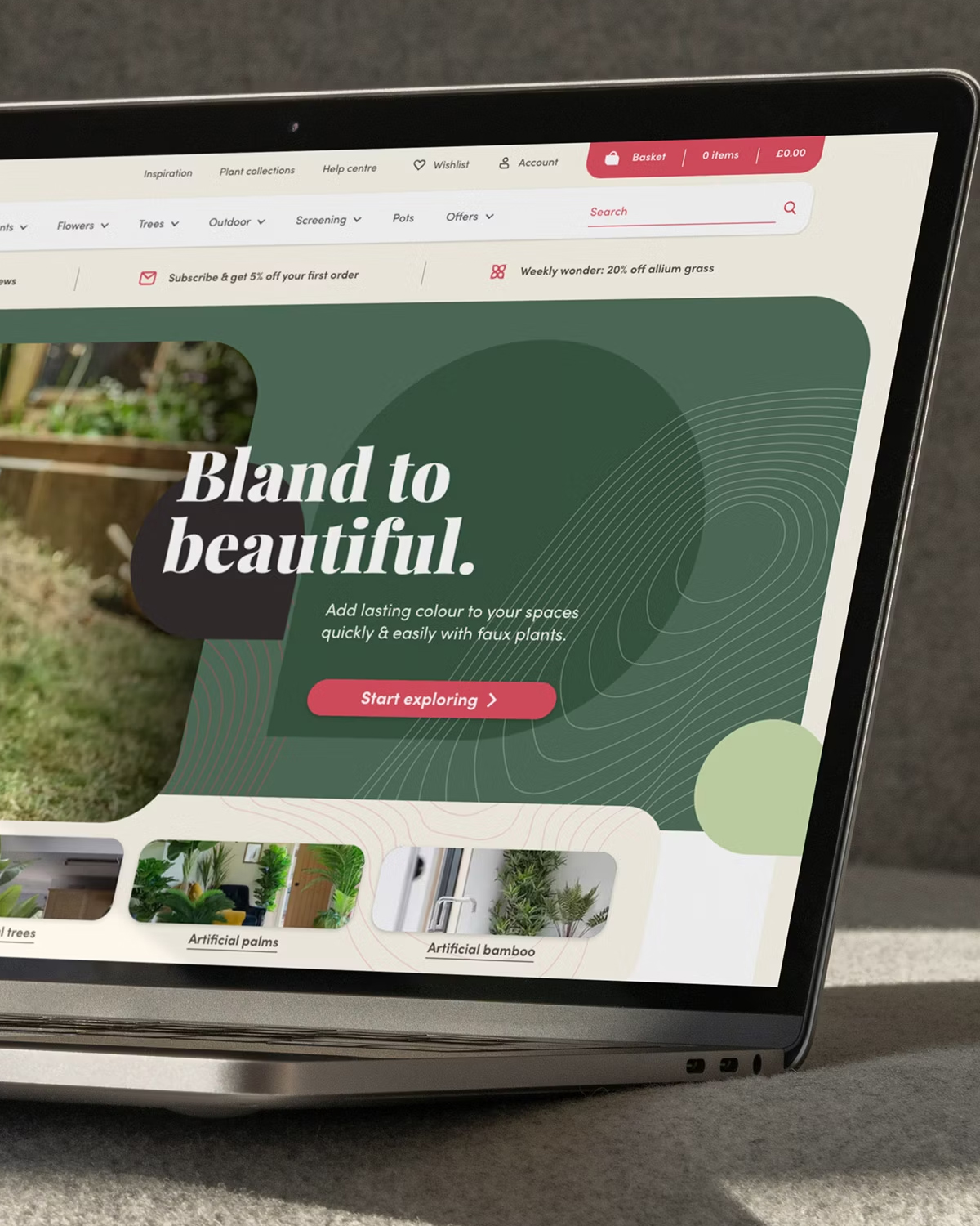 A laptop displaying the Blooming Artificial website, featuring a promotional banner for artificial plants with the slogan 
