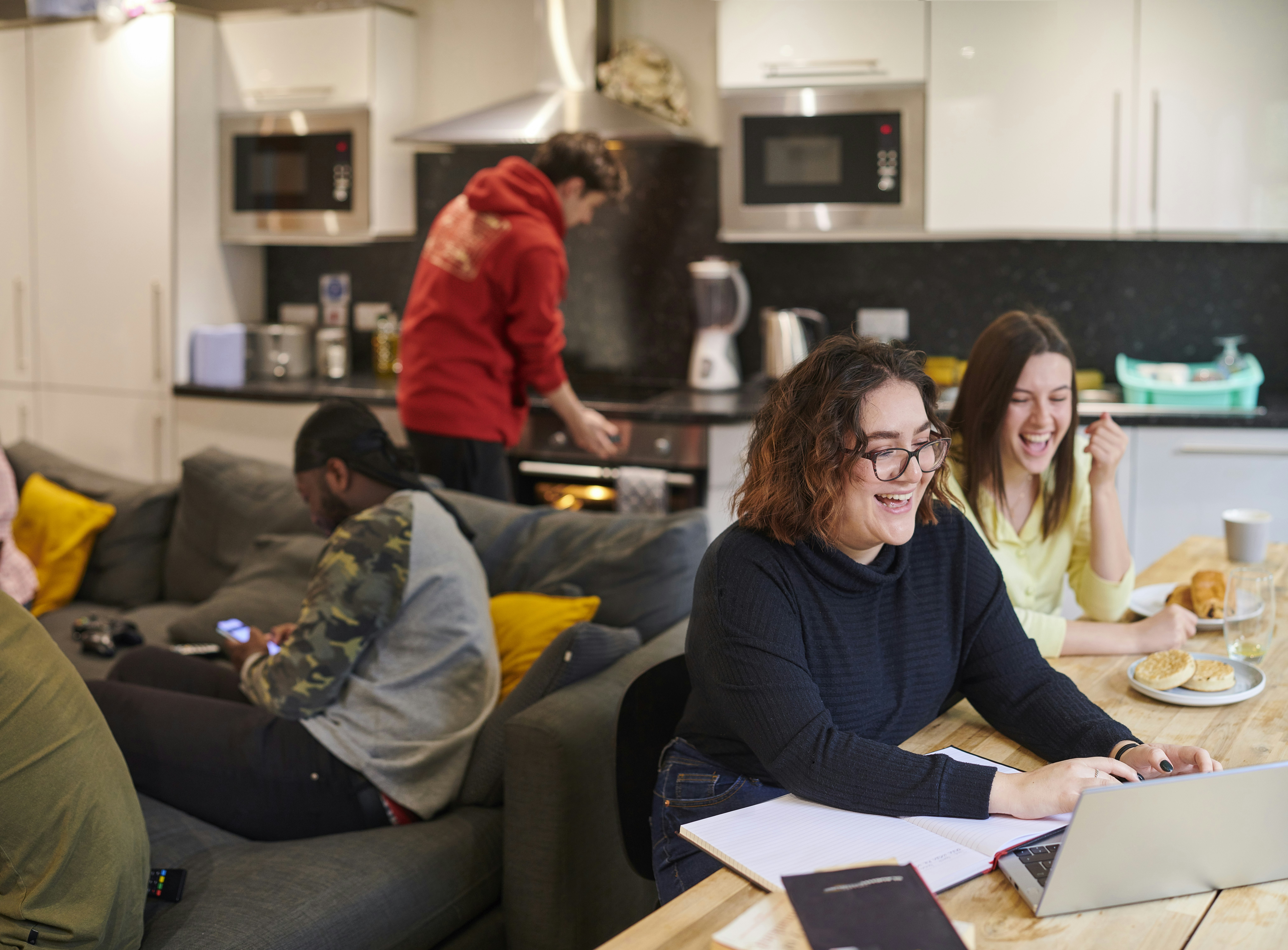 A group of happy young people in a shared student accommodation.
