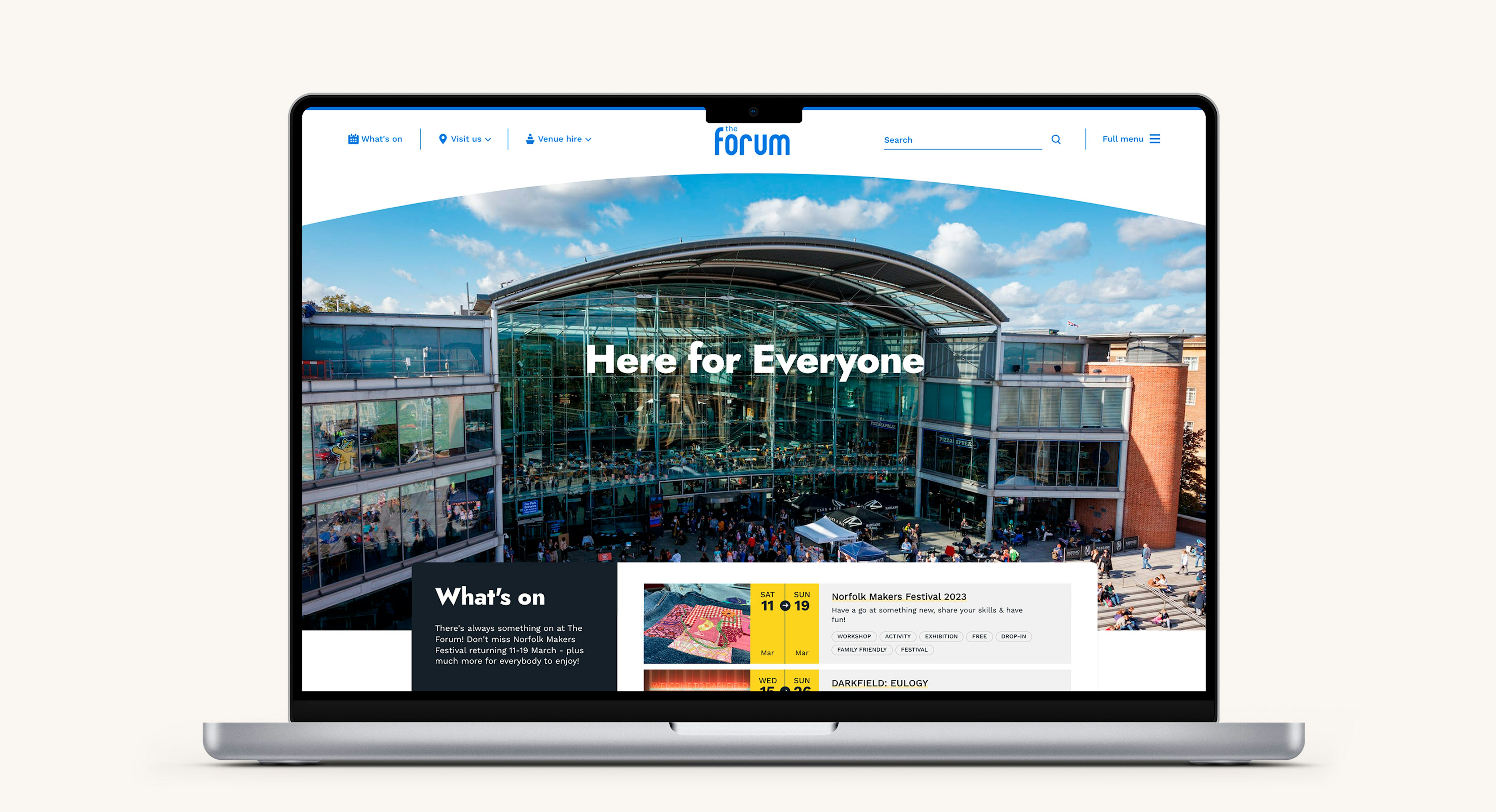 An open laptop computer displaying the hero section of The Forum website
