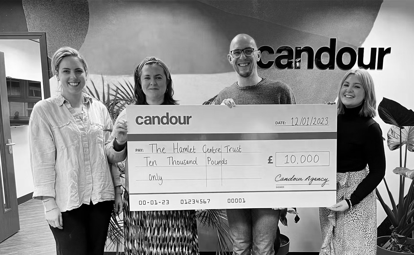 Candour directors presenting a large cheque for £10,000 to the Hamlet Centre Trust
