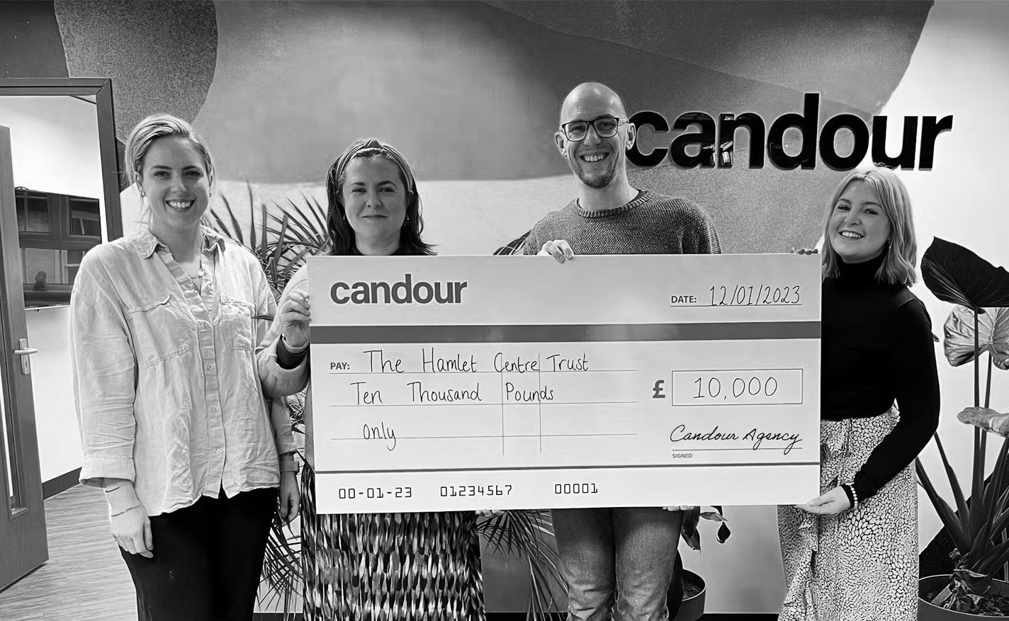 Candour directors presenting a large cheque for £10,000 to the Hamlet Centre Trust
