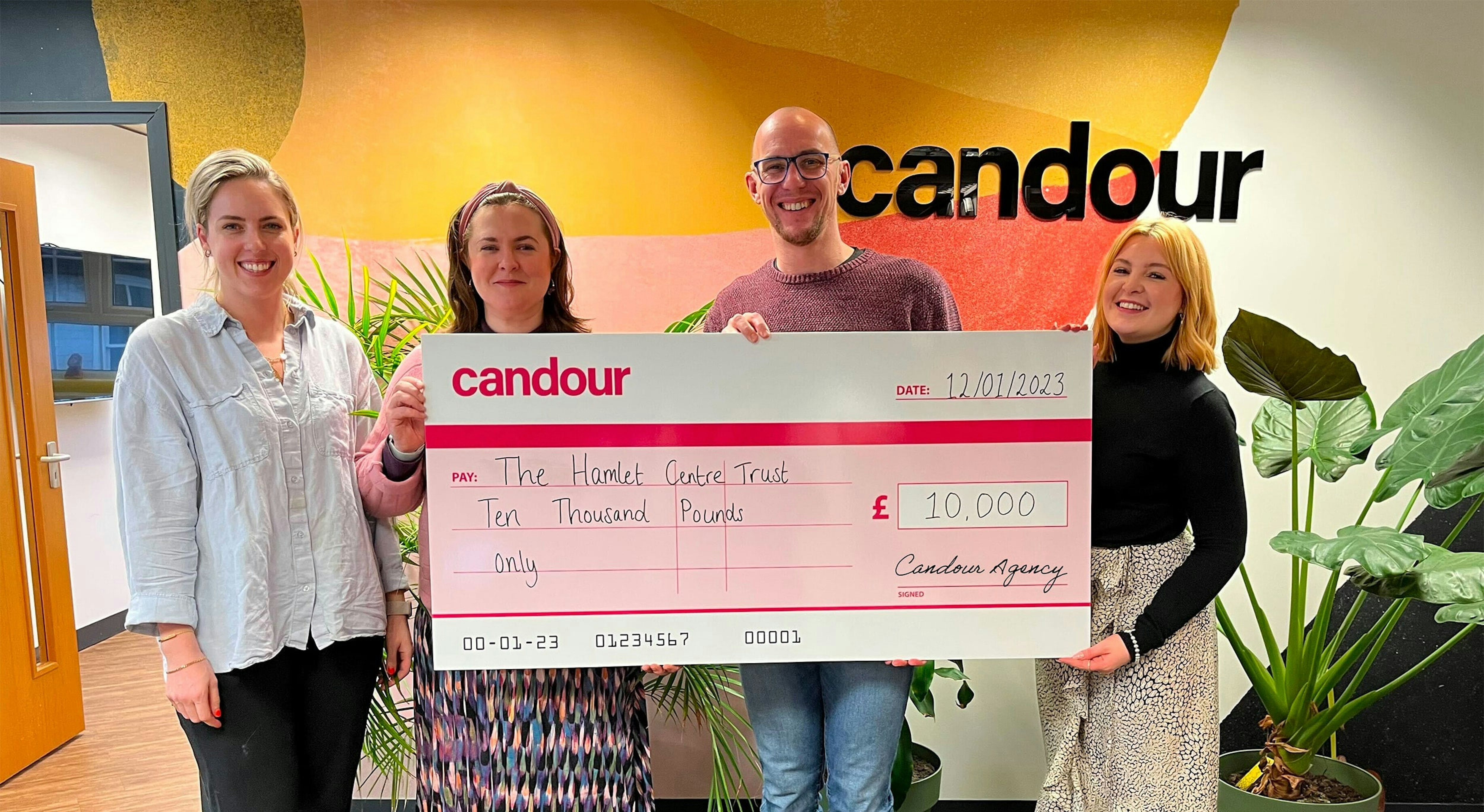 Candour team handing a large cheque to The Hamlet Centre Trust