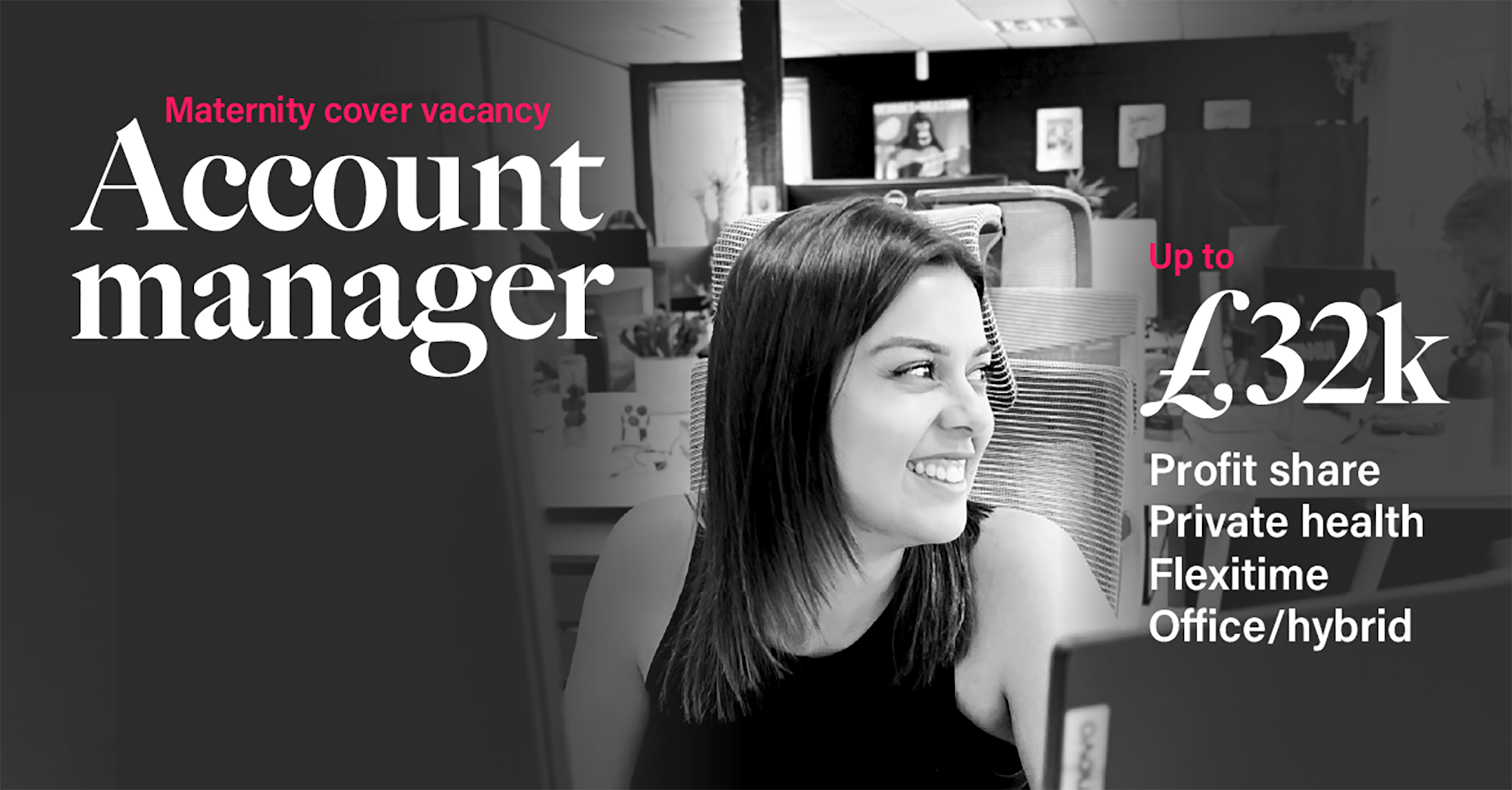 Hannah sitting at her desk smiling