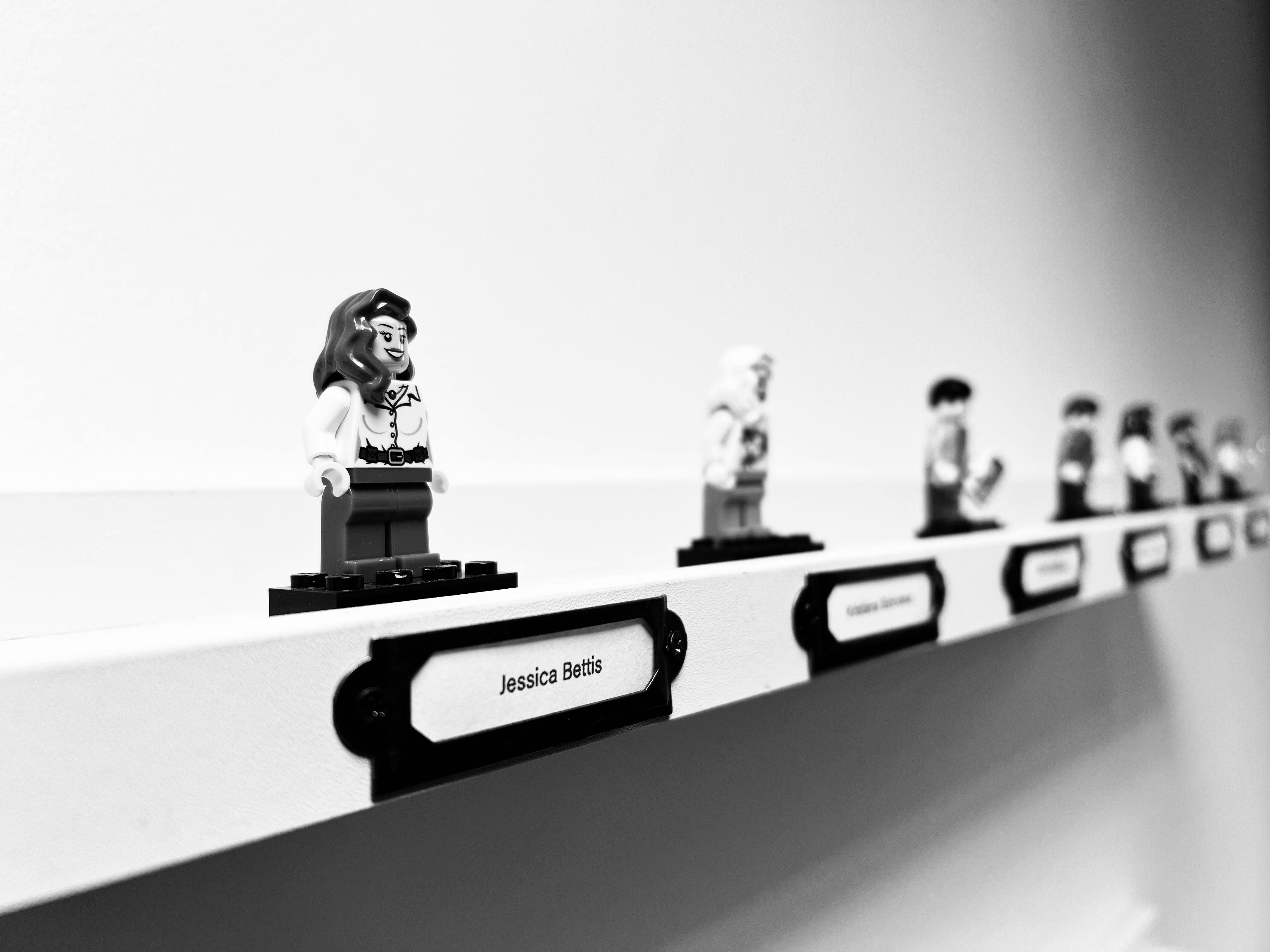 A row of Lego figures on a shelf representing team members at Candour agency.