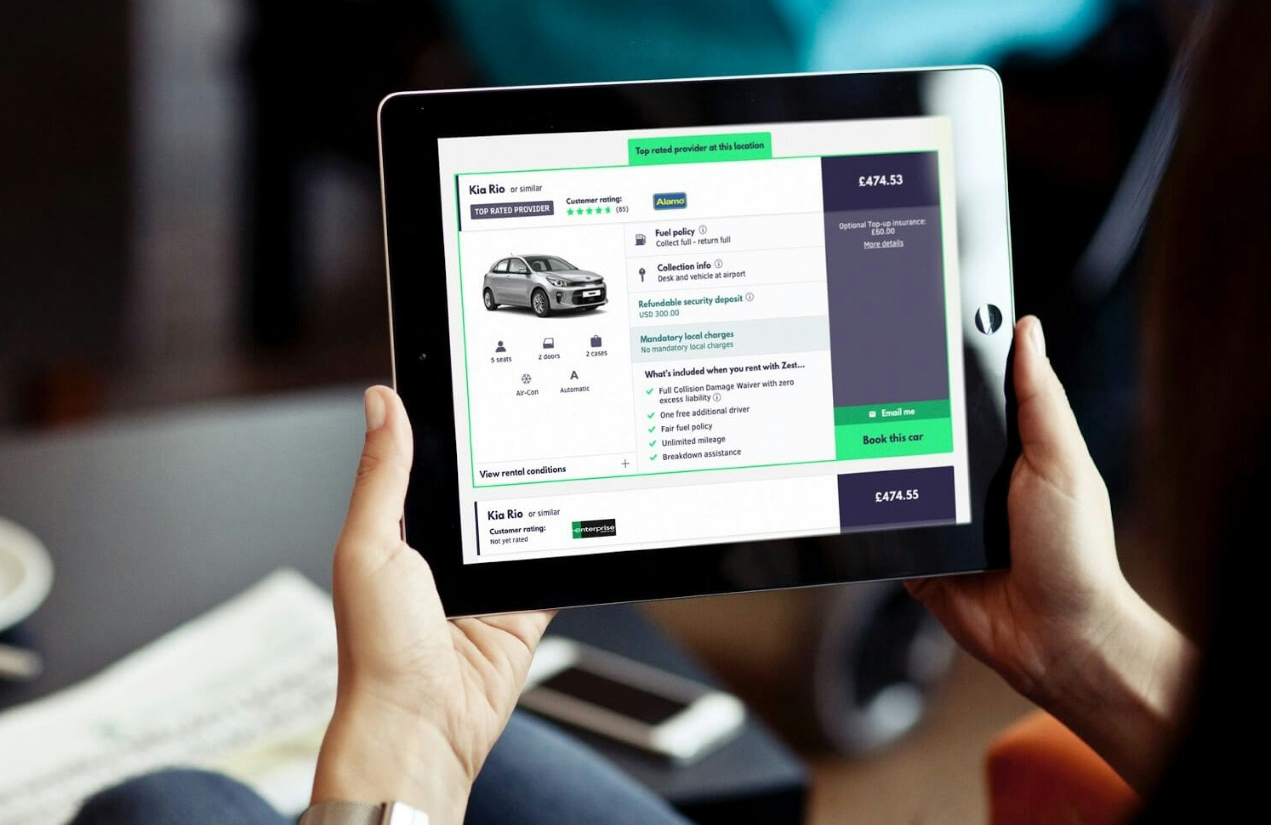 A person holding a tablet displaying a Zest Car Rental booking page, featuring a Kia Rio rental option with pricing, fuel policy, and included benefits like zero excess liability and breakdown assistance.